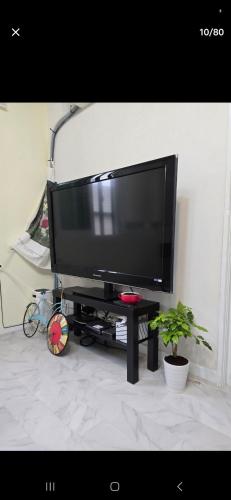 a flat screen tv sitting on a stand in a living room at K Story House LOVE HAPPY in Daegu
