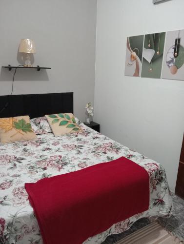 a bedroom with a bed with a red blanket at Fontinele's Home Apt 201 in Nova Iguaçu