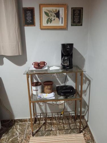 a glass table with a coffee maker on it at Fontinele's Home Apt 201 in Nova Iguaçu