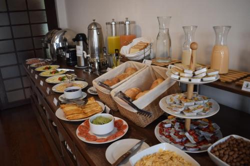 a buffet with many plates of food on a table at Hotel Villa del Carmen in Arequipa