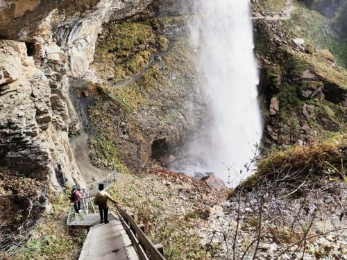 a group of people standing on a bridge over a waterfall at Eden Kleinbichl Top 7 in Tamsweg