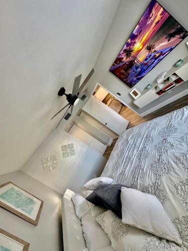 a bedroom with a bed and a flat screen tv at Waterfront Condo by the Marina in Clewiston