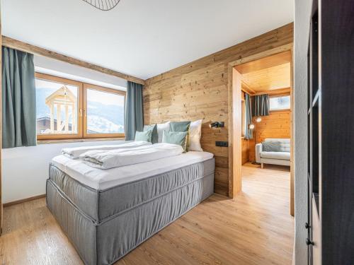 a bedroom with a large bed in a room at Tirola Chalet Alpbach in Alpbach