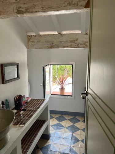 a kitchen with a sink and a counter with a window at Casa Bitxu in Mahón