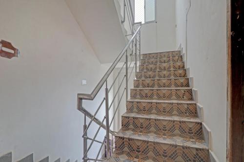 a staircase in a building with a metal railing at Hotel O Ki & Kaa in Dānāpur