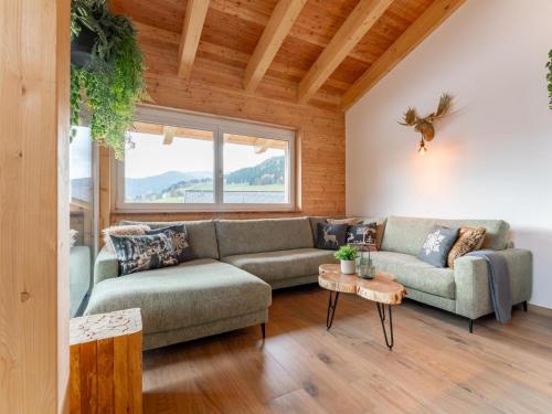 a living room with a couch and a table at Grebenzen Lodge Edelweiss in Sankt Lambrecht