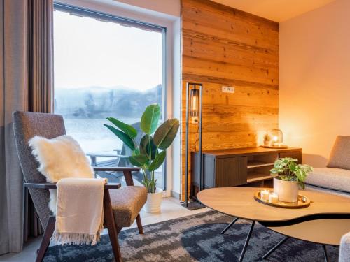 a living room with a table and chairs and a large window at Mountain Chalet Aquarius 5A in Sankt Lorenzen ob Murau