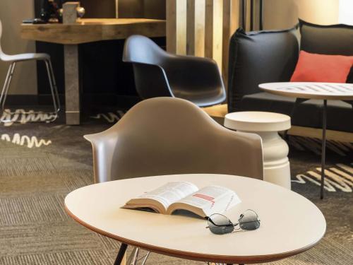 a table with a book and glasses on it at ibis Angers Centre Chateau in Angers