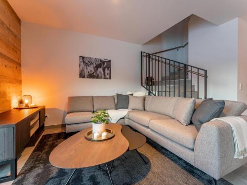 a living room with a couch and a table at Mountain Chalet Aquarius 5A in Sankt Lorenzen ob Murau