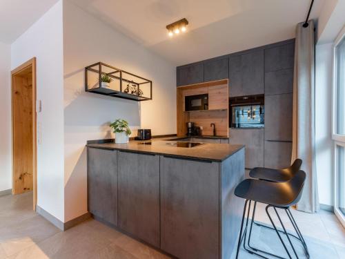 a kitchen with a counter and a chair in a room at Mountain Chalet Aquarius 5A in Sankt Lorenzen ob Murau