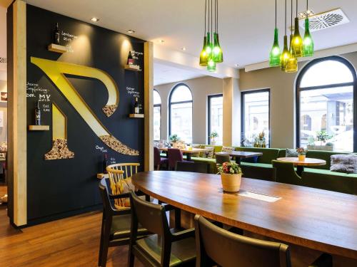 a restaurant with a large letter k on the wall at Mercure München City Center in Munich