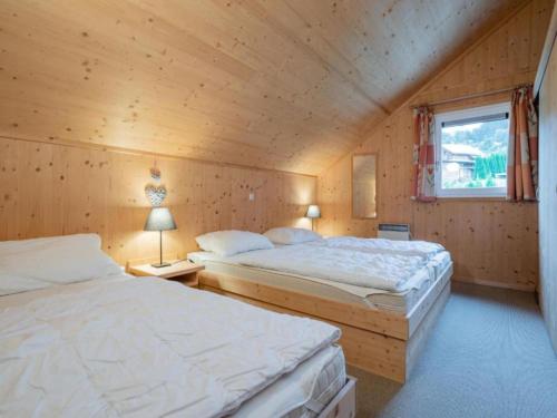 a bedroom with two beds and a window at Baier in Steindorf