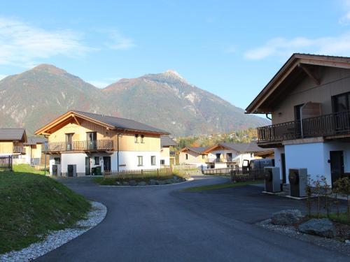 a road in a village with mountains in the background at Obermöschach 13 in Obermöschach