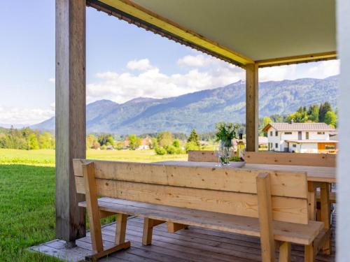 a porch with a bench and a view of mountains at Obermöschach 13 in Obermöschach