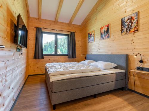 a bedroom with a bed in a wooden room at Obermöschach 13 in Obermöschach