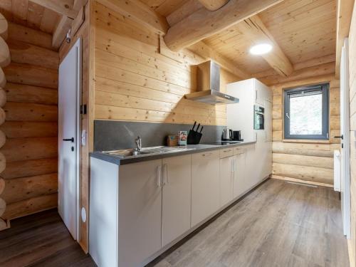 a kitchen with white cabinets and wood walls at Jenig 5A in Jenig