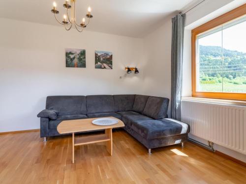 a living room with a couch and a table at Jukbichl 1 in Laas