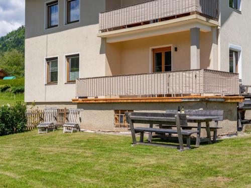 a bench in the grass in front of a house at Jukbichl 1 in Laas