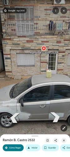 a silver car parked in front of a building at Business Home in Olivos