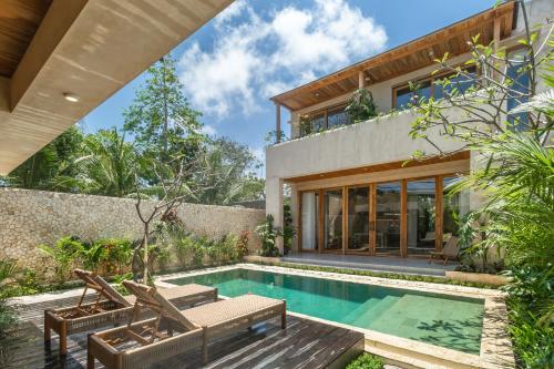 a home with a swimming pool and a house at MINTU Villa Uluwatu - BBQ, Private Pool & Concierge Service in Bingin Beach