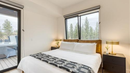 a bedroom with a bed and large windows at 1115 Aerie Buyout 2 Units Near Downtown Hot Tub Mountain View in Bend