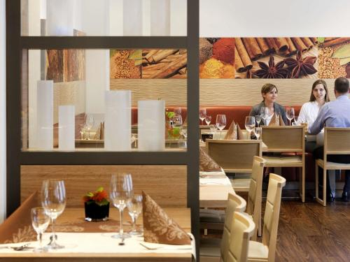 people sitting at tables in a restaurant with wine glasses at ibis Aachen Marschiertor - Aix-la-Chapelle in Aachen