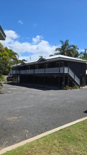 a large black building with a parking lot at Agnes Palms Motel in Agnes Water