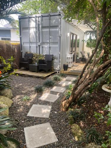 a garden with a patio and a house at Tropical Garden Retreat in Napier