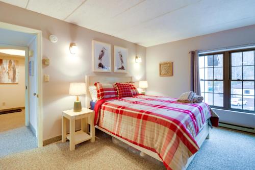 a bedroom with a bed and a window at Game Room and BBQ Waterfront Lake Harmony Condo! in Lake Harmony