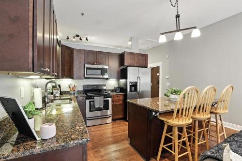 a kitchen with wooden cabinets and a counter top at NEW LISTING The Classic City Collection - 3 Separate Units in Athens