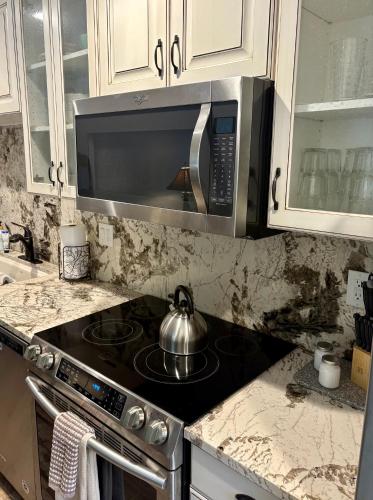 a kitchen with a stove with a tea kettle on it at Eagles Roost Haven - Cozy Ski View Condo in Brian Head