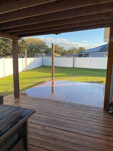 a patio with a wooden deck with water on it at Modern Escape in Kissimmee in Kissimmee