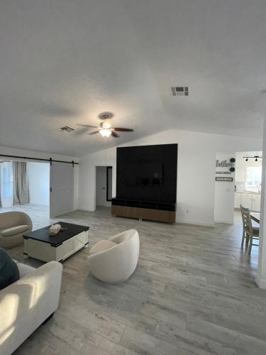 a living room with a couch and a flat screen tv at Modern Escape in Kissimmee in Kissimmee