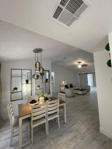 a dining room and living room with a table and chairs at Modern Escape in Kissimmee in Kissimmee