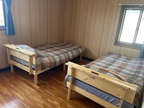 Postel nebo postele na pokoji v ubytování ゲストハウスまみむ