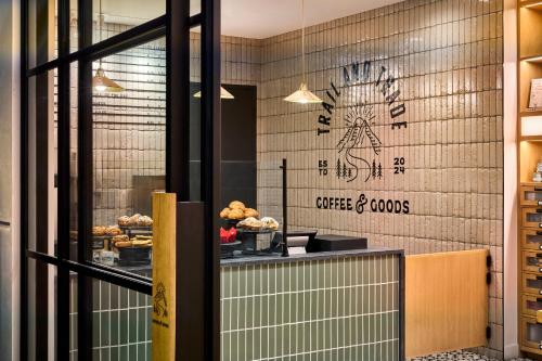 a bakery with a coffee and cookies sign on the wall at Omni Interlocken Hotel in Broomfield