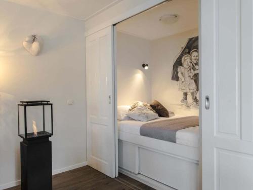 a room with a bed with a mirror in it at Holiday home in Nes with swimming pool in Nes