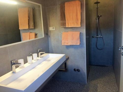 a bathroom with two sinks and a shower at Holiday apartment in Tisno with swimming pool in Tisno
