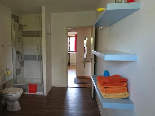 a bathroom with a shower and a sink with towels at One-bedroom apartment in Inzell