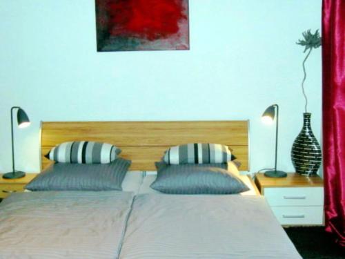 a bedroom with a bed with two pillows at Holiday apartment in Konz with swimming pool in Könen
