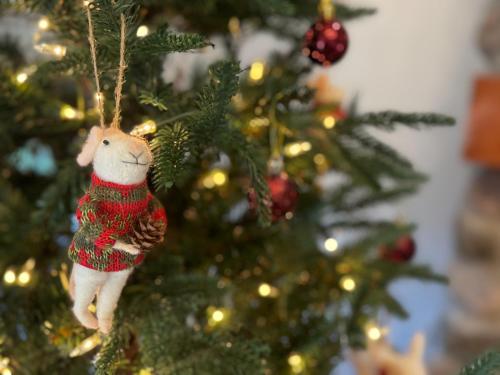 a christmas ornament hanging from a christmas tree at Bella and Dulce's Lakehouse in Union Pier