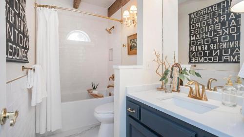a bathroom with a sink and a toilet at 35 Acre Estate w Pool Spa Wine Cellar Gym Near Golf Club La Pearla Ranch by AvantStay in Kingston Springs