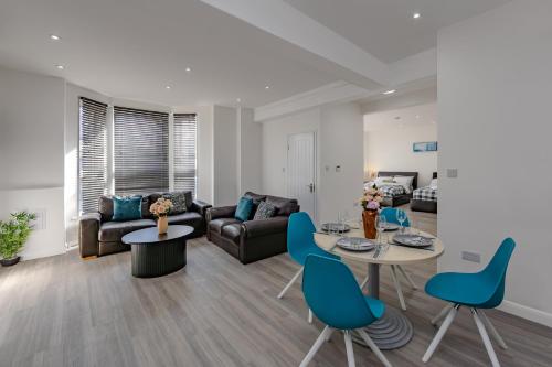 a living room with a couch and a table and chairs at Triple B Aparto in Clacton-on-Sea