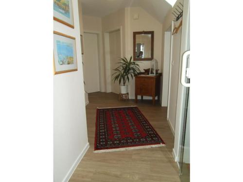 a hallway with a rug on the floor and a mirror at Holiday apartment with 2 bedrooms in Kirchlinteln