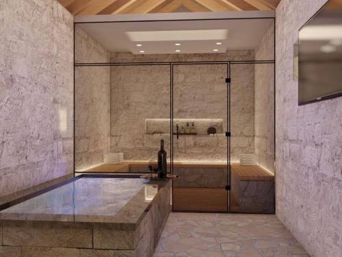 a bathroom with a shower with a sink at Villa Marina - Five Bedroom Villa With Pool in Mlinište