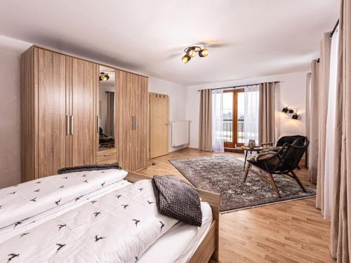 a bedroom with a bed and a chair in a room at Time out at the mountain spring in Mitterbach
