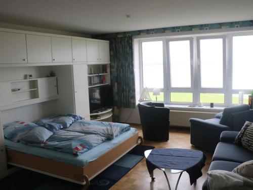 a living room with a bed and a couch at One-bedroom apartment in Cuxhaven