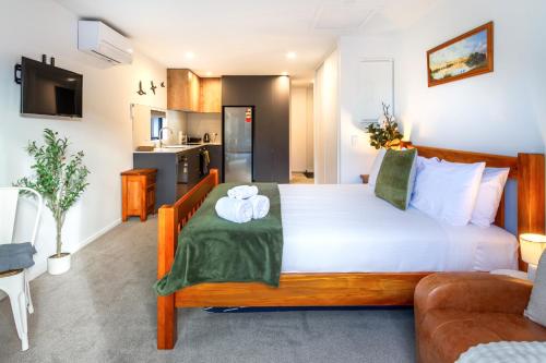 a bedroom with a large bed in a room at The Nest - Modern Studio Retreat with Parking in Christchurch