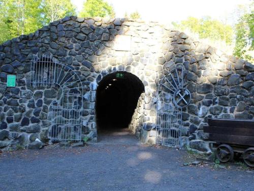 a tunnel in a stone wall with a bench in it at Julia and Markus Sitzmann in Bischofsheim an der Rhön