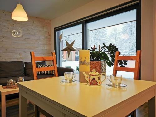 a dining room table with two chairs and a table with glasses on it at Julia and Markus Sitzmann in Bischofsheim an der Rhön